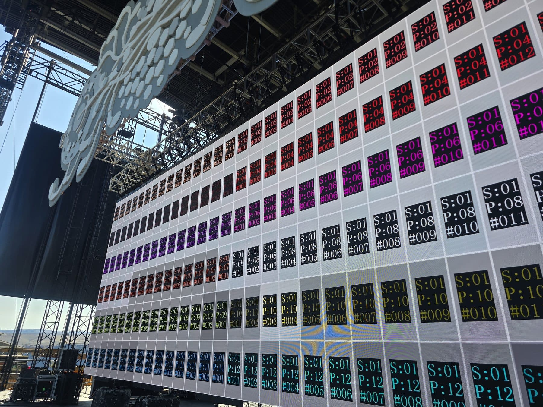 Large LED wall displaying per-cabinet identification and port assignments during commissioning